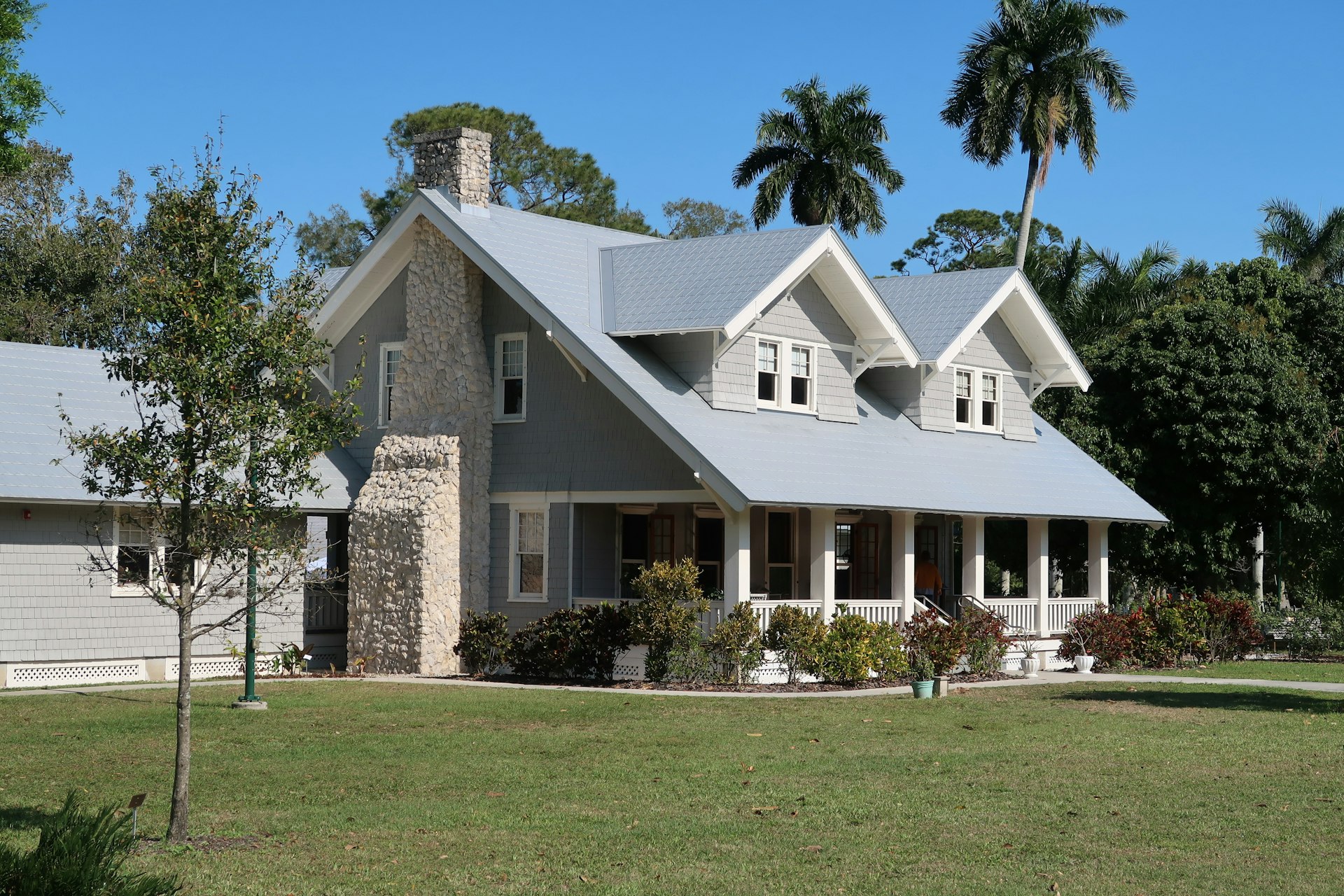 Gray craftsman-style two-story home with white trim and a front porch